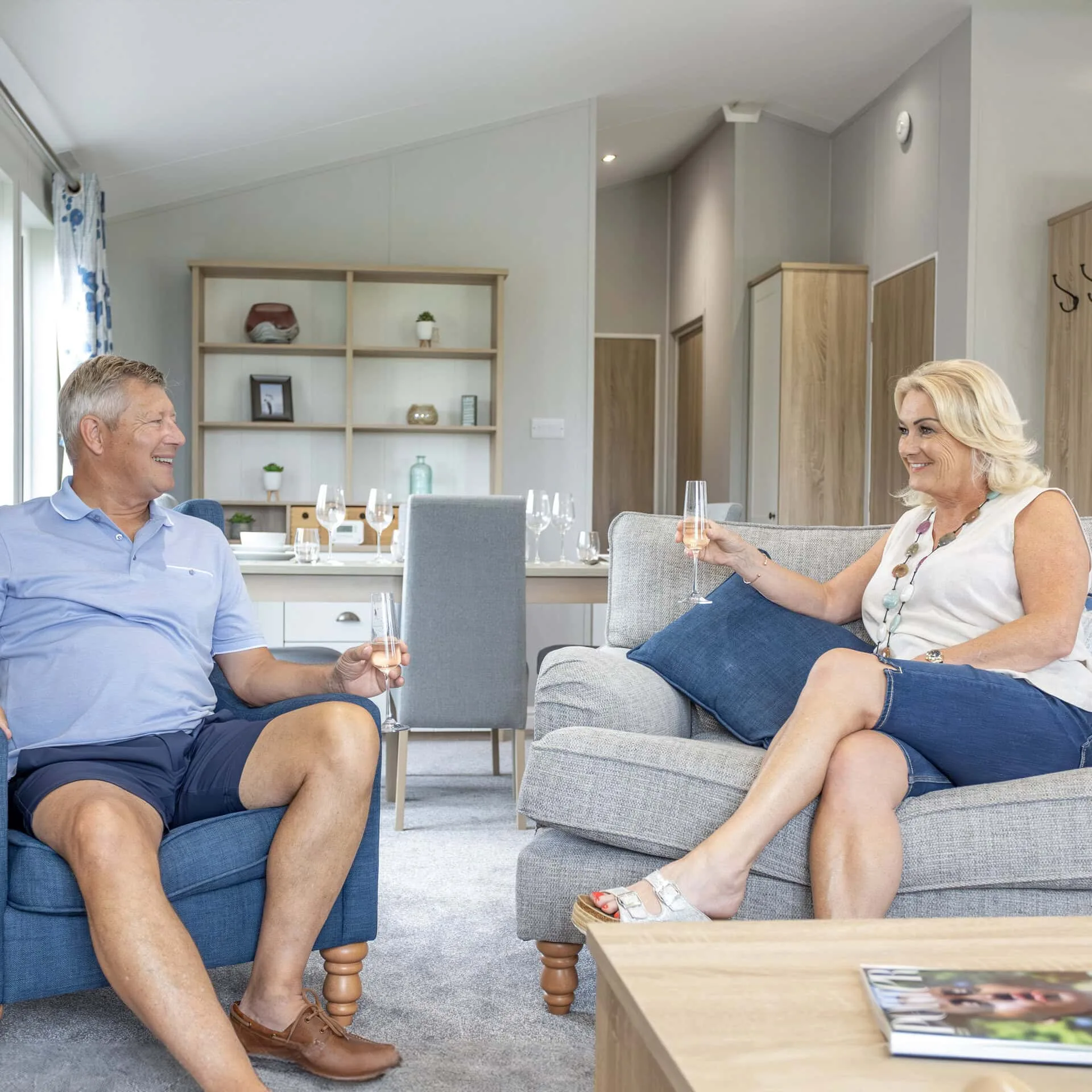 Couple relaxing together on the sofa in a luxury lodge at Heathergate