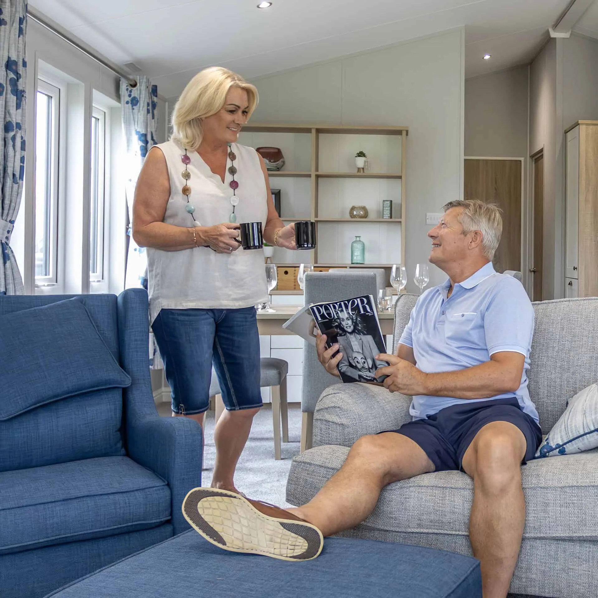 Couple enjoying their time in the living room area of a Heathergate lodge