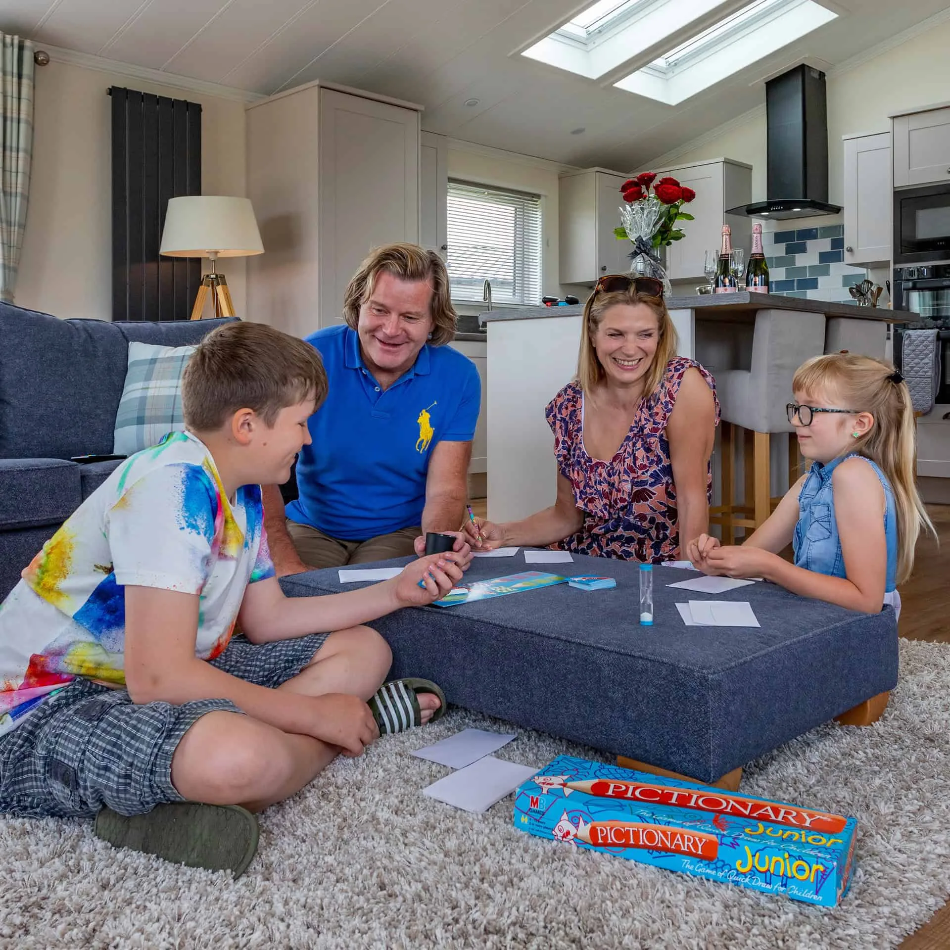 Family playing board games in the living room of a Heathergate lodge