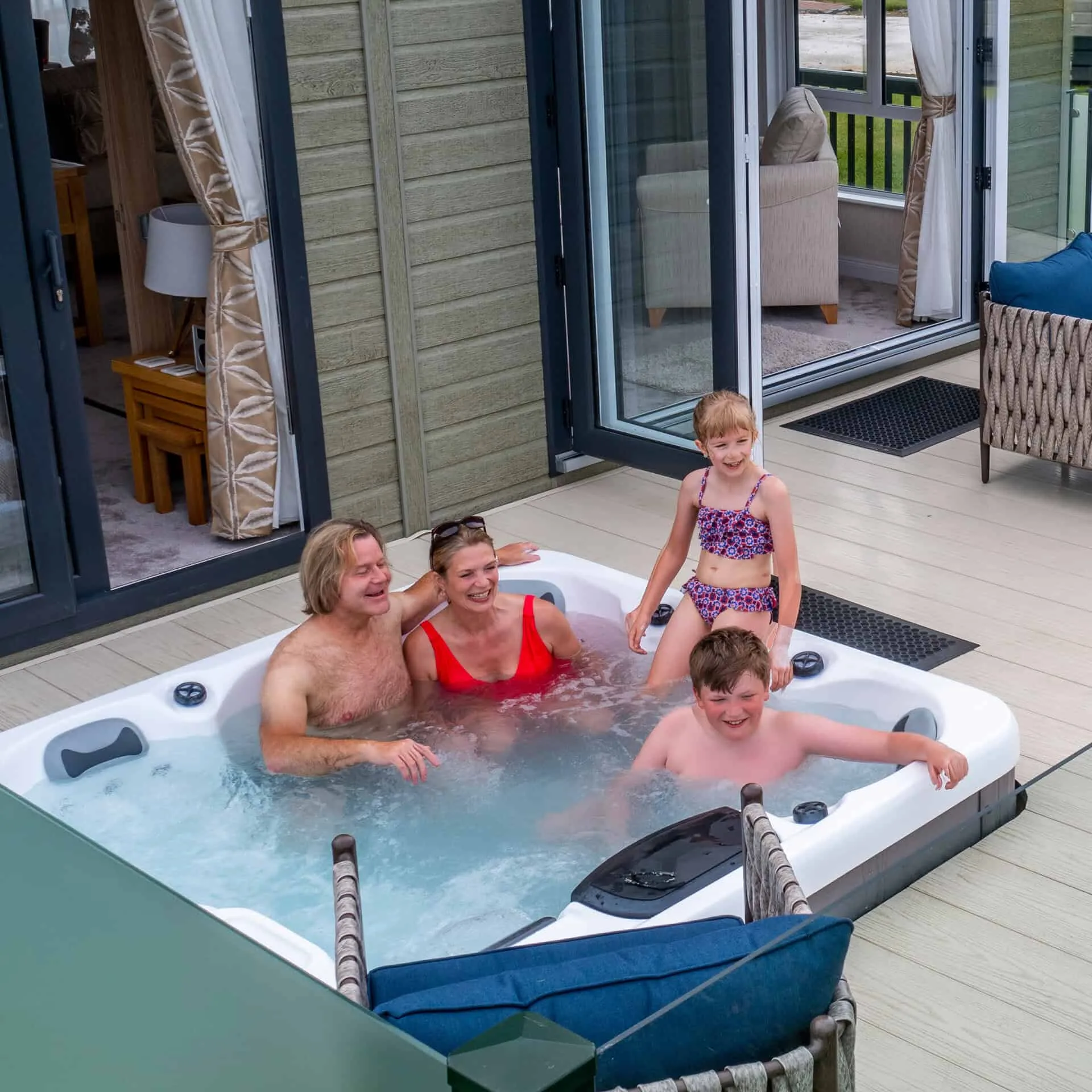 Family enjoying a hot tub at a luxury lodge at Heathergate