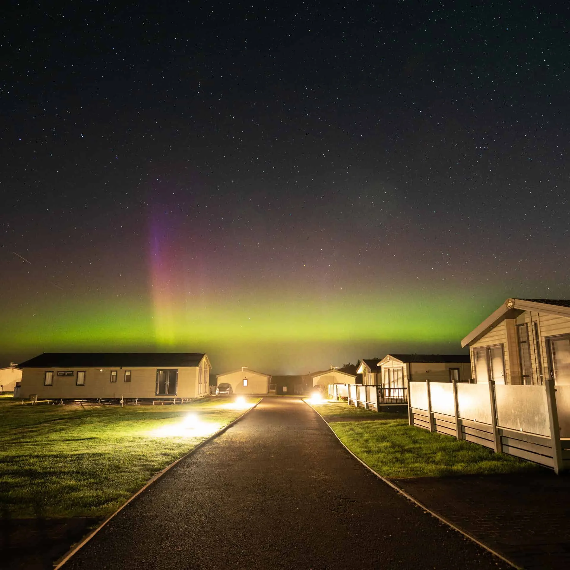 View of luxury lodges at Heathergate at night.