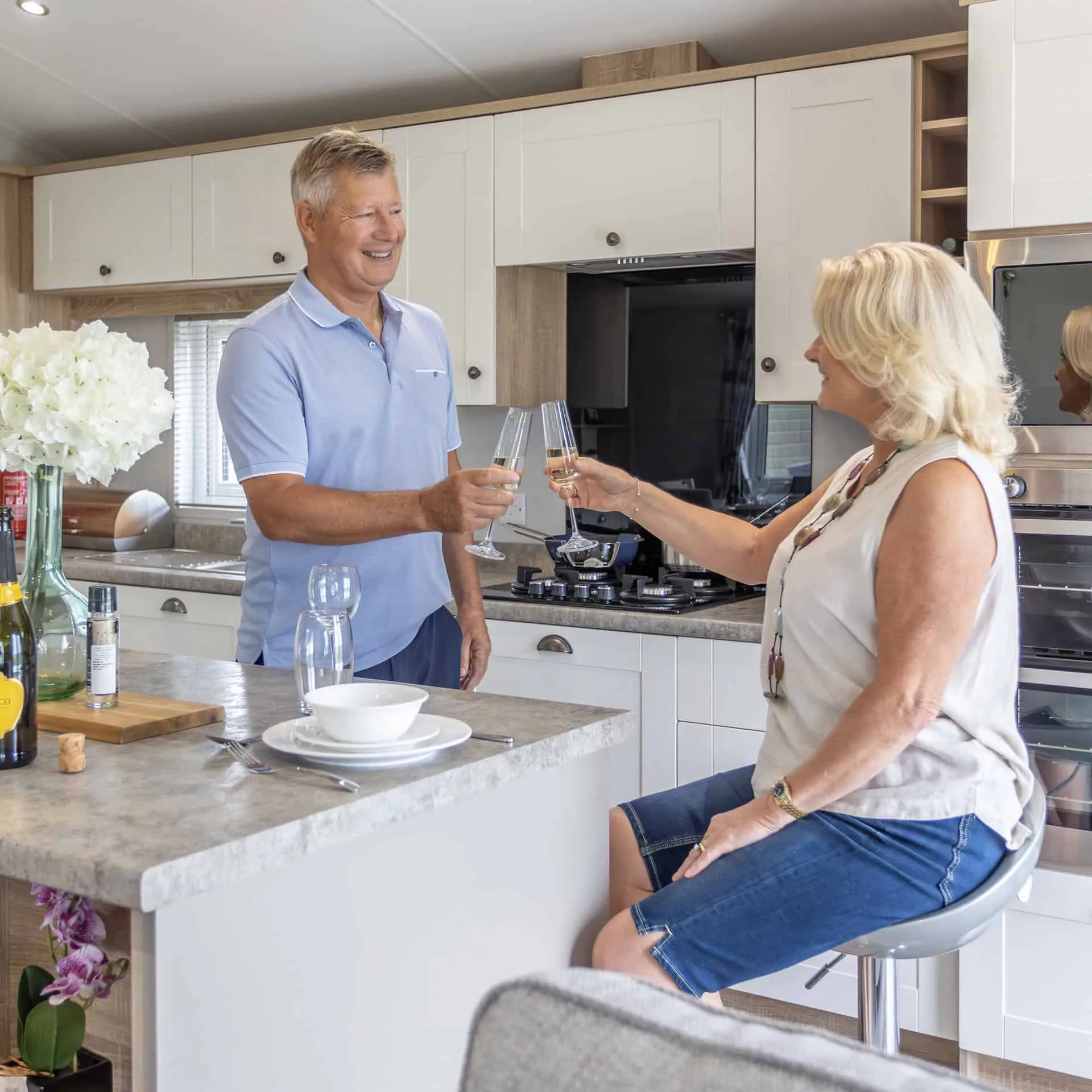 Couple enjoying their time in the kitchen area of a Heathergate lodge